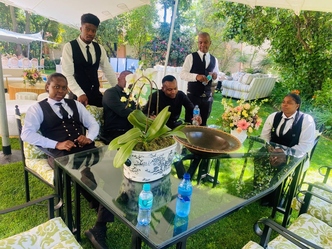 TM Events team setting and serving an elegant garden banquet
