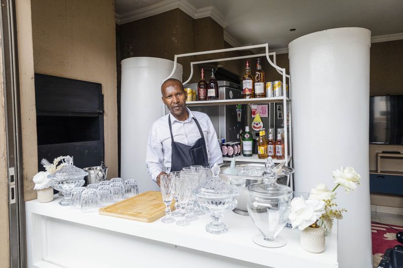 TM Events bartender at a fully set up bar with glassware